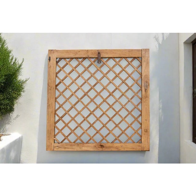 A bleached wood window panel with a see-through cross weave design. Originally lattice window panels were used to let air...