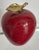 Mid-century maroon marble apple paperweight with brass stem detail. This would make an excellent addition to a bookshelf,...