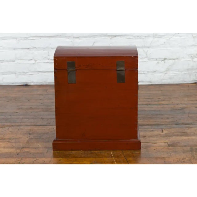 An antique Chinese Qing Dynasty period red lacquer treasure chest from the 19th century with gilded calligraphy, low...