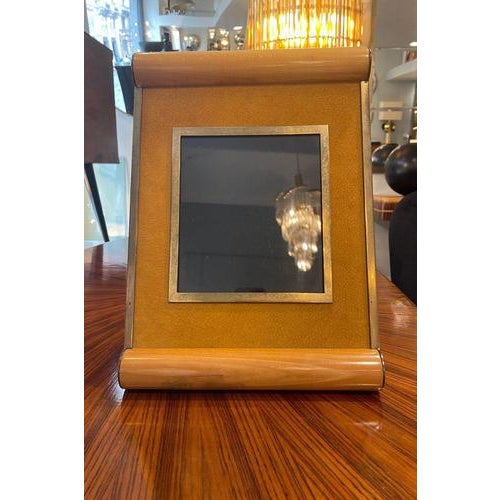 Distinctive wooden photo frame with brass details on the front and sides. The upper and lower bases are made of...
