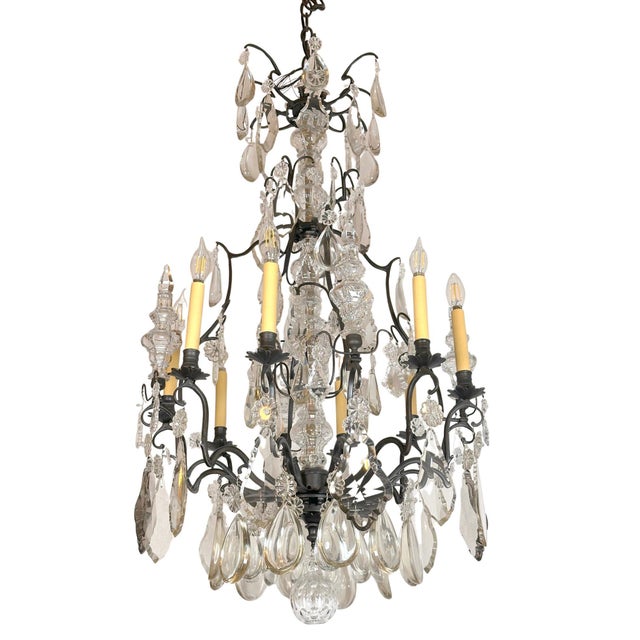 Louis XV style cage chandelier draped in clear crystals and gray rock crystals on a black finish bronze frame. It features...