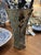 Tall fluted glass vase decorated with a decoupage collage of botanical prints, foliage patterns, and antique map fragments...