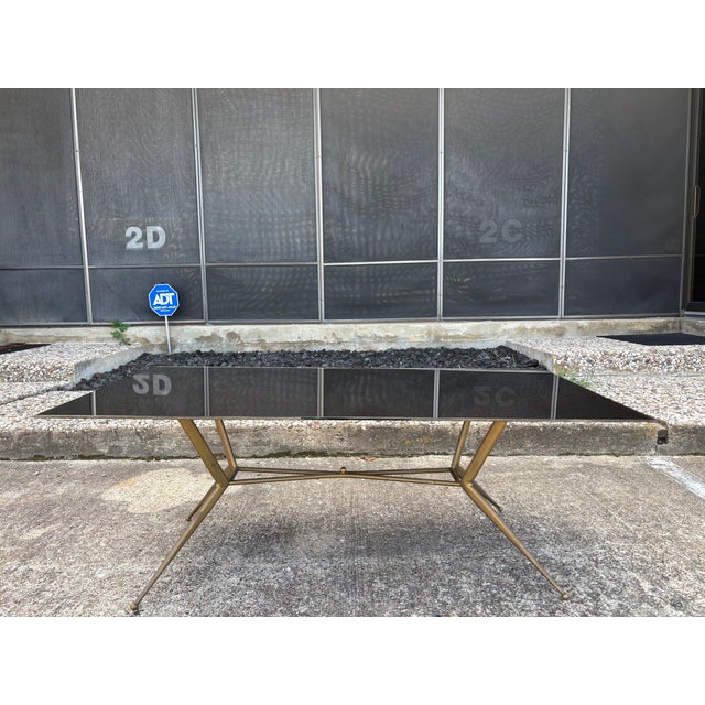 Italian Modern Bronze Cocktail Table. Offered is a glamorous Italian mid-century bronze cocktail table or coffee table...