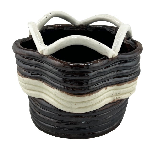 A striking vintage studio pottery vessel featuring a sculptural basket form with applied looping handles and richly...