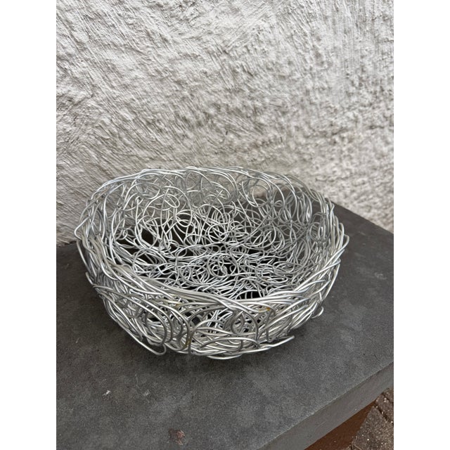 Twisted metal bowl designed by Fratelli Champana for Alessi, Italy. The bowl is marked on the bottom.