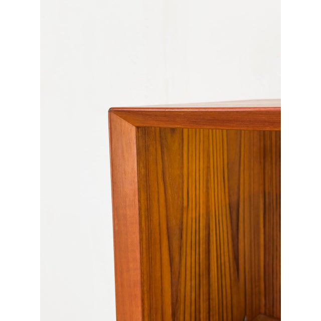 High-quality and timeless teak bookcase with four shelves, each with a beveled front. The second shelf from the bottom is...