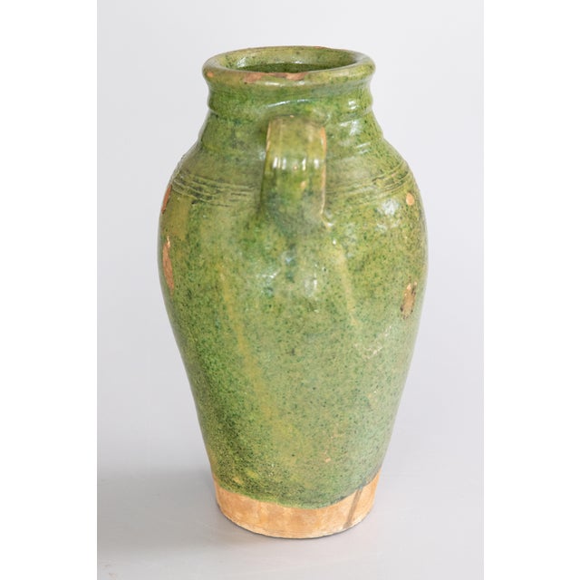 A superb 19th century French Provençal green glazed terracotta olive jar or urn. These jars were used for storing and...