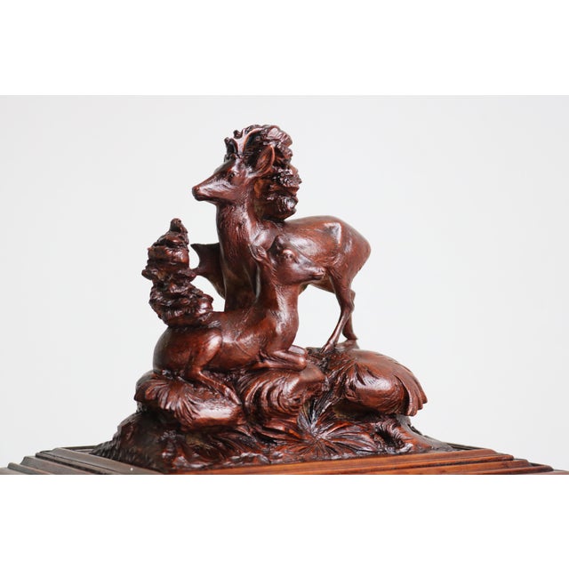 Rare and impressive, this 19th-century hand-carved Swiss Black Forest cigar box is crafted from rich walnut, offering a...