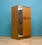 A mid century Uniflex wardrobe in warm teak veneer, with a clean front and recessed handles. Fitted with a mirrored door...
