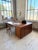Antique double-sided desk with a double pedestal topped by a large walnut slab adorned with a geometric border and inlays....