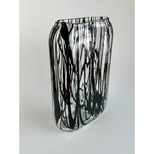 This modernist vase was produced in Murano, Italy- circa 1950. It features an oval body with a slight shoulder and was...