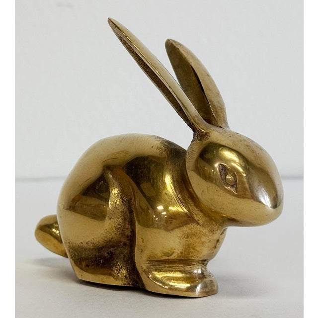 Vintage brass bunny seated with ears perked. Would make a great paper weight or decorative accessory. Patina.