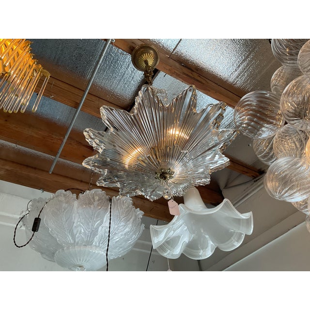 Bring a touch of classic glamour into your home with this gorgeous crystal pendant. The flower‑shaped glass panels sparkle...