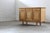 A sideboard crafted in the style of Henning Kjærnulf, showcasing oak construction with excellent craftsmanship. It...