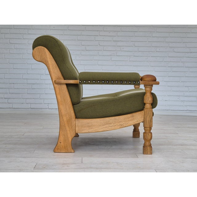 1970s, Danish armchair in original very good condition: no smells and no stains. Green furniture wool fabric, solid oak...