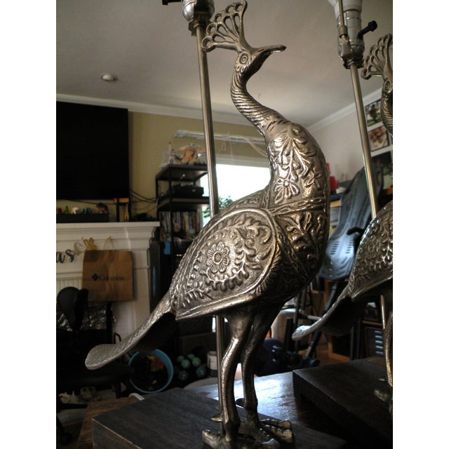 Introduce a beautiful, unique focal point to your home with these ornate metal peacock lamps. The silver-tone metal is...