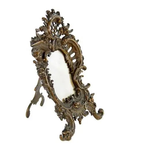 An elegant and exquisitely crafted bronze photo frame, reflecting the exceptional artistry of the late 19th century. The...