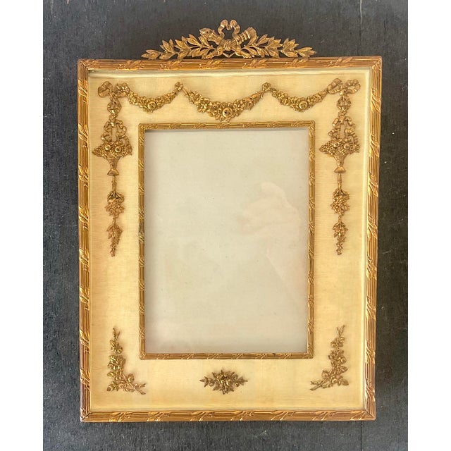 French Neoclassical Gilt Bronze Picture Frame. Large ornate Neoclassical gilt bronze picture frame embellished with floral...