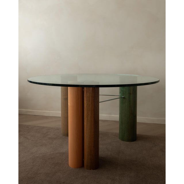 A vintage postmodern italian glass dining table with enamel-finished column base, made for saporiti italia and produced in...