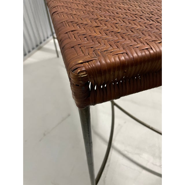 Woven rattan over an iron frame, this table was.purchased from the Conran Shop in Georgetown, DC, in 1990. Frame has a...