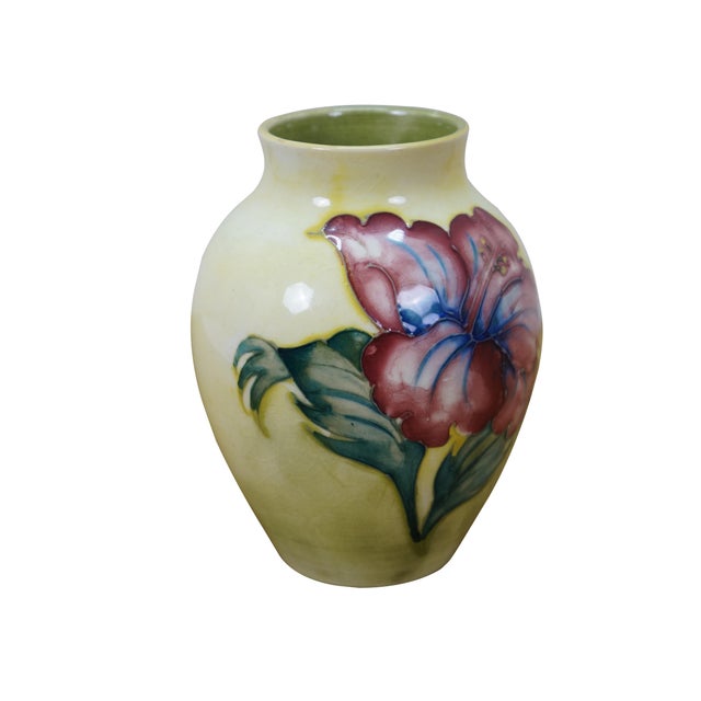 Mid Century Moorcroft pottery vase in the Hibiscus pattern. The vase features large blue and yellow hibiscus flowers with...