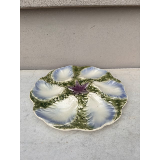 French Majolica plate with blue starfish with six wells blue and white surrounded by green seaweeds signed Digoin (East of...