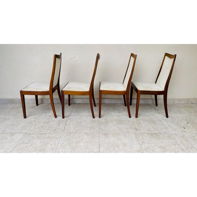 Exquisite set of four dining chairs by G-Plan, the iconic British mid-century design house. These chairs feature an...