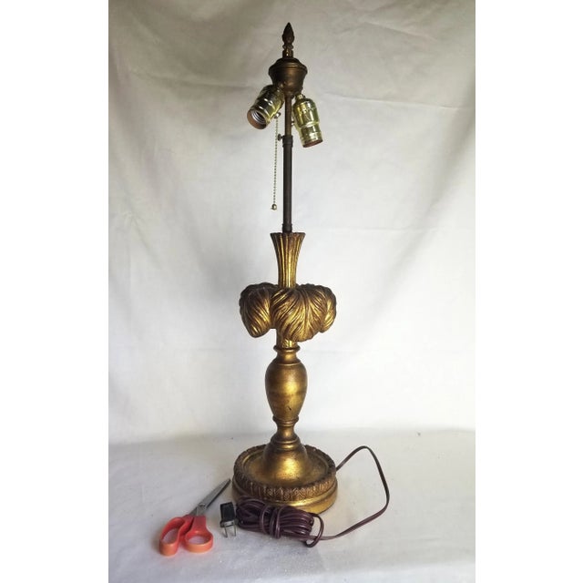 Gilt plaster lamp, with vase shaped turning with leaves coming out and arching back down. Lovely patina. The stem used to...