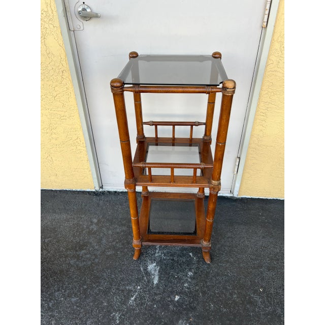 Small wood etagere shelf standing 38” tall. This could be used in a bathroom or as a side table. The 3 glass shelves as...