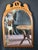 1930s Maple Hanging Wall Mirror featuring a graceful arched frame with a decorative pierced crest in the Colonial Revival...