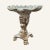 These low grotto stools with shell seats were popular in the 19th century. This Griffon stool is a Hollywood Regency...