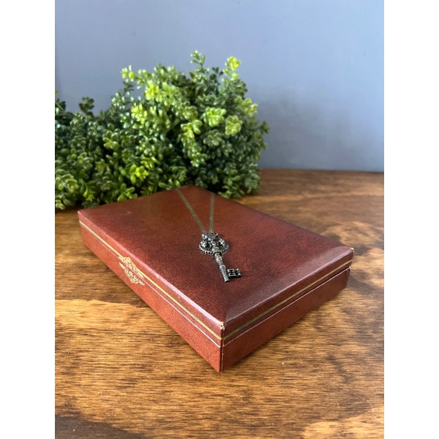 Vintage 1950s Swank leatherette jewelry box with raised metal key on the front. Made in Sweden. Couple spots of wear sign...