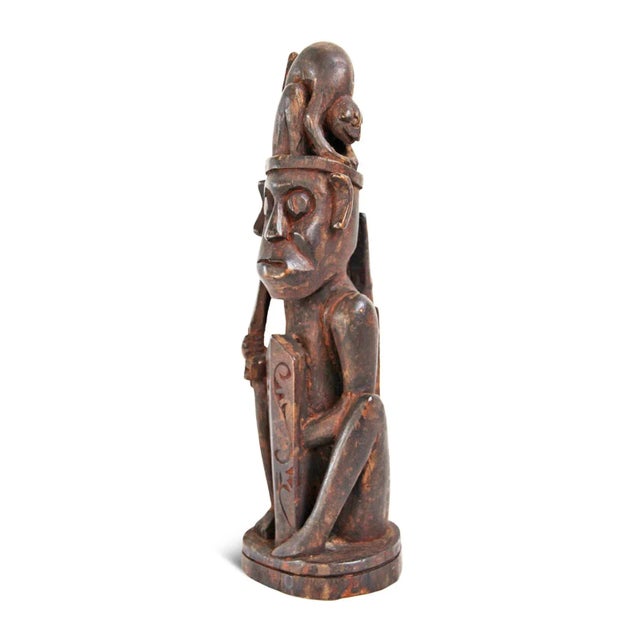 Original wood carved male hunter tribal figure from Borneo. Collected in the 1950's.