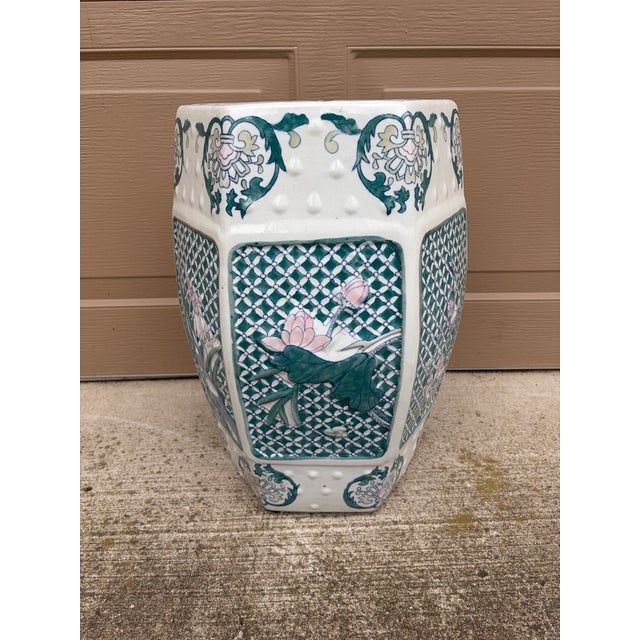 A gorgeous Chinoiserie blue, white, pink, and green porcelain garden stool, plant stand, or small side table featuring...