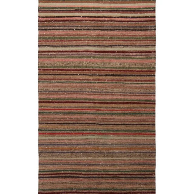 Hand woven in Turkey originating between 1970-1980, this vintage wool kilim rug enjoys a play of subtle, intricate...