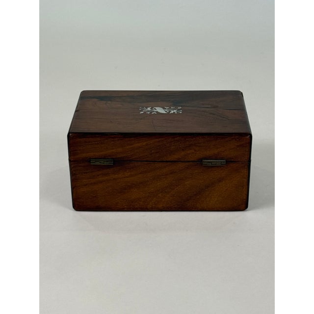 French 19th Century Box made of exotic rosewood The top and the keyhole of the petite trunk is inlaid with Mother of...