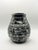 A beautifully hand-carved solid black marble vase featuring striking natural white veining and a sculptural ribbed...