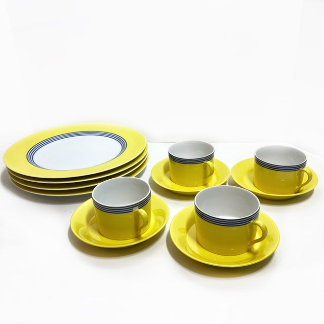 Vintage set of luncheon dishes from Fitz and Floyd. The "Circa" design sports a bold yellow with deep blue rings. Set...