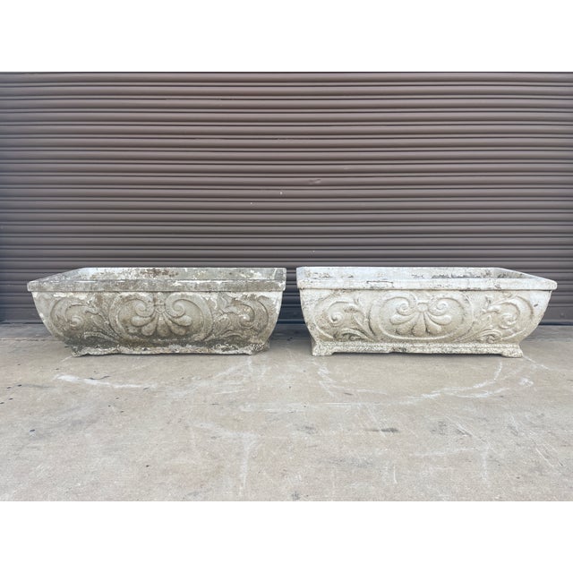 A rare and striking pair of rectangular cast stone planters, recently rescued from a historic estate in the New Orleans...