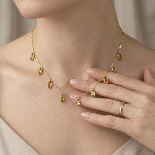 Add a touch of warmth and elegance to your jewelry collection with this exquisite Marquise Citrine Station Necklace....