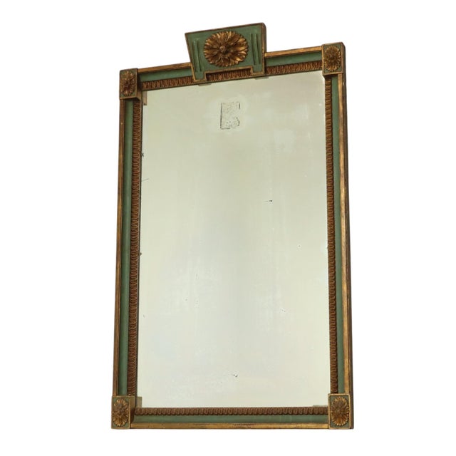 A magnificent large mirror made of wood and plaster with green and gold accents; manufactured in France and bearing a...