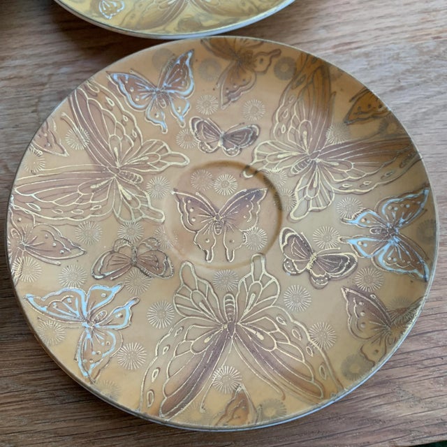 Set of four coasters from the 1960s by Dorothy Thorpe. Matte gold and shiny gold designs.