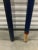 This pair of wooden oars features rectangular flat heads with cylindrical handles in colorful hand painted graphics.