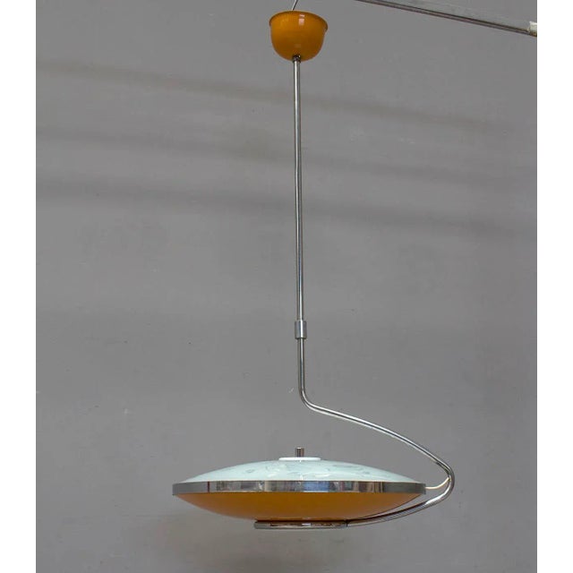 Chandelier 70s with dual lighting system. Light directed downwards and diffused light upward, with the decoration that is...