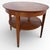 This mid century coffee table is a round two tier teak table with brass capped legs, designed to bring both style and...