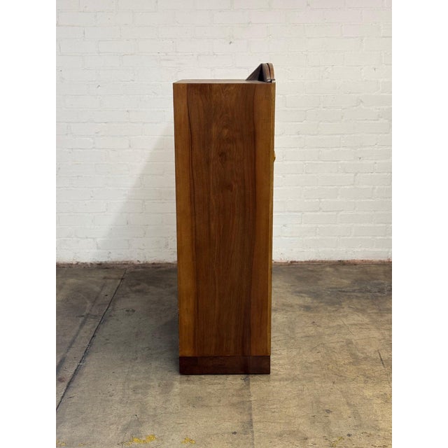 W32.5 D19 H62 Fully restored vintage armoire with striking flamed walnut burl wood along the face of the piece. The...