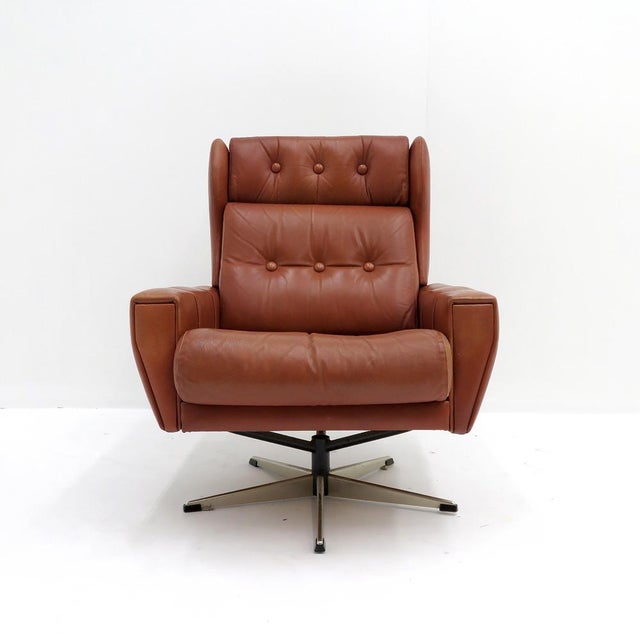 wonderful wingback leather lounge chair attributed to Svend Skipper Möbler, 1970, upholstered in cognac colored tufted...