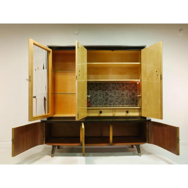 This highboard is an original piece from the 1950s. It consists of two sections and is very well-made. Exclusive features...