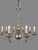 This vintage chrome Flemish-style chandelier features eight sweeping branches extending from a central baluster column....