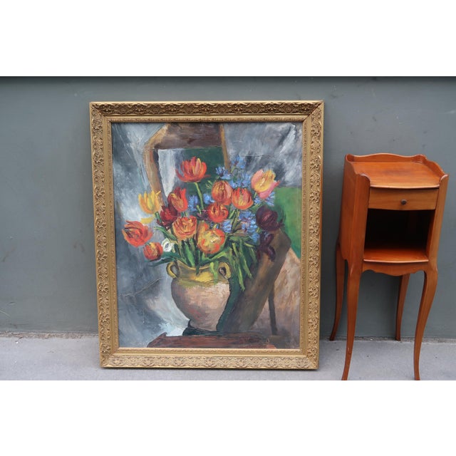 Beautiful antique French oil painting depicting a generous bouquet of tulips and blue flowers arranged in a decorative...